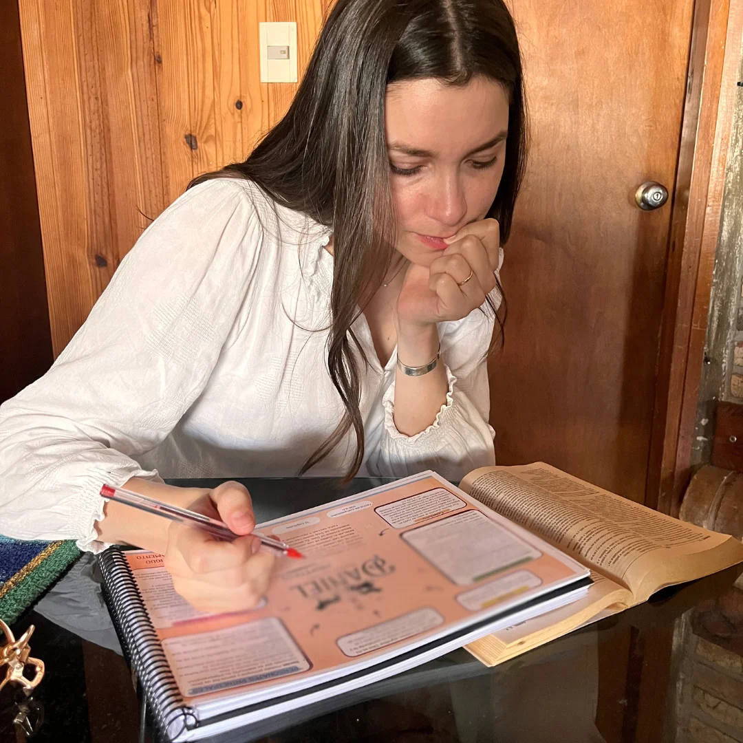 Woman studying the Bible Map alongside her open Bible